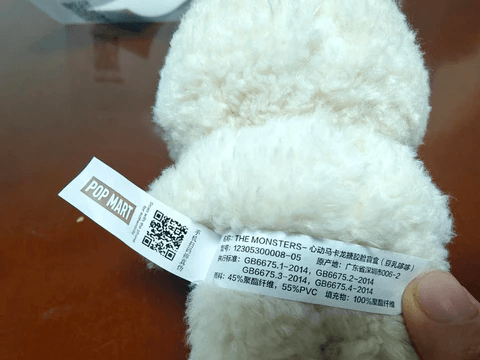 A collector scanning a Pop Mart QR code on a Labubu blind box