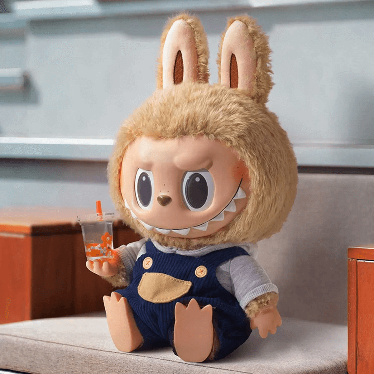 A Labubu plush with a custom-made raincoat and umbrella
