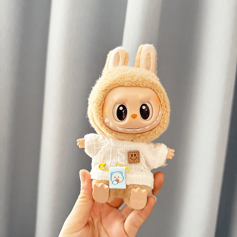A Labubu doll's closet neatly organized with tiny hangers and outfits