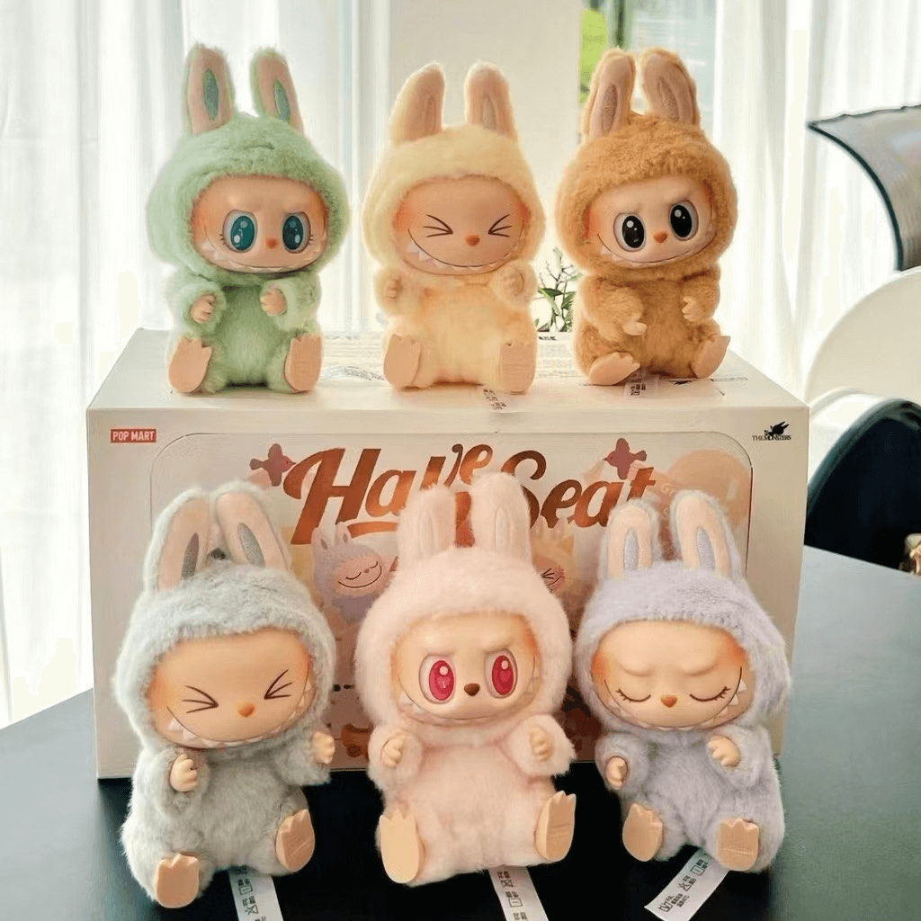 Labubu plush and vinyl figures with their original packaging
