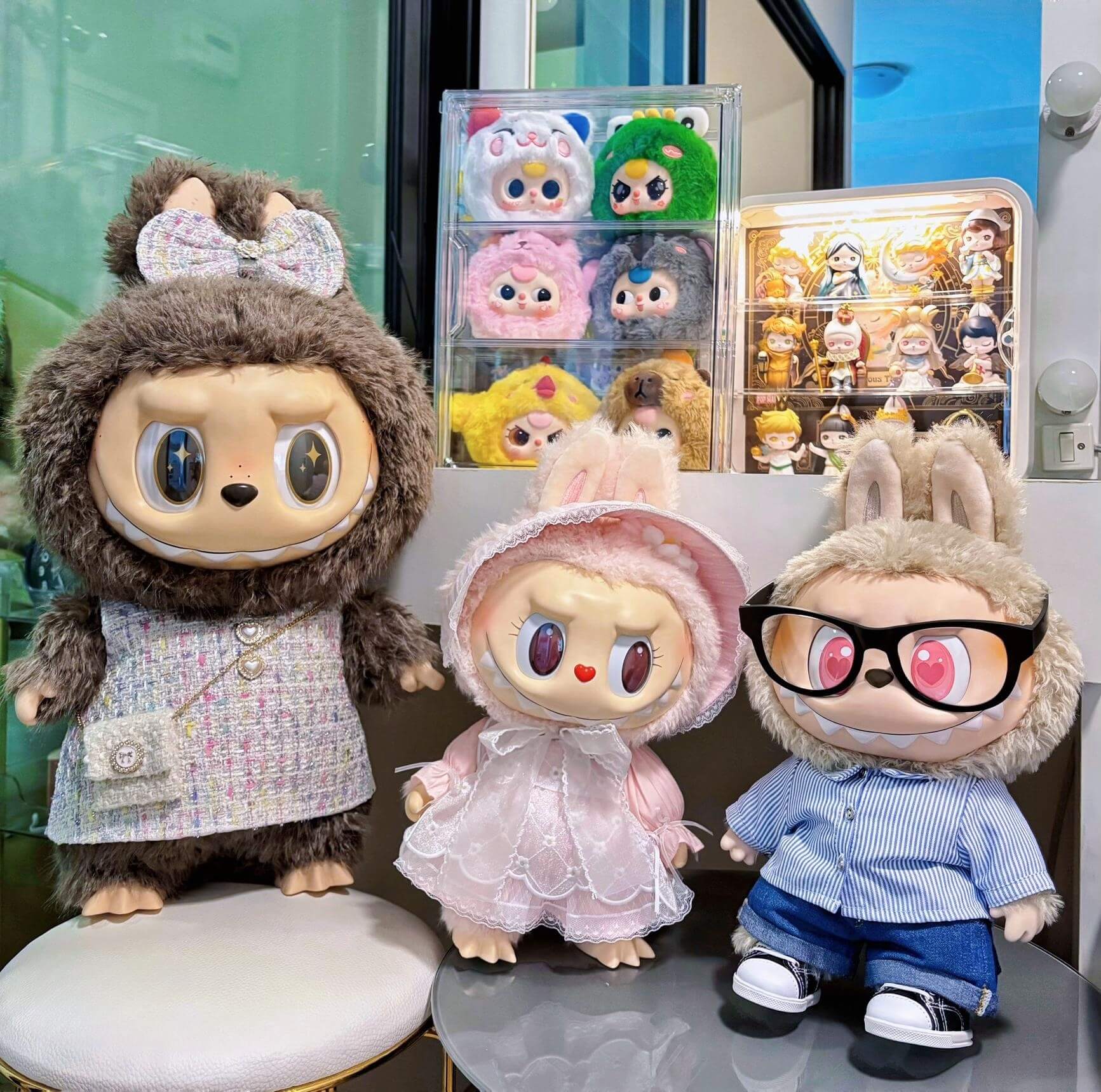 A vibrant display of Labubu, Zimomo, and Mokoko figures lined up on a collector’s shelf